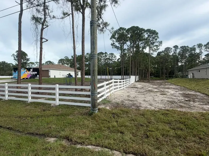 White vinyl ranch rail fence along a rural Central Florida property